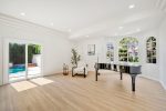 Presto S60 Gloss Black piano shell staged in a bright living room